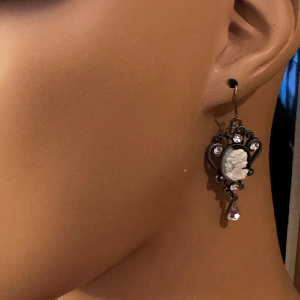 Silver tone cameo drop earrings with rhinestones